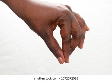 African American Hand Sprinkling Salt And Spices In Or Holding Some Object Isolated On White Background. 