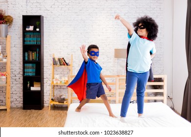 African American Happy And Confident Young Kids Playing 
 And Dressing Up As Superhero Together In Bedroom