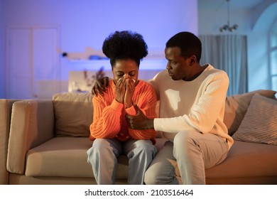 African American Husband Consoling Wife In Tears. Abuser Guy Feeling Sorry For Being Rude And Aggressive During Family Fight Or Quarrel Embrace Crying Girl. Domestic Violence And Partner Abuse Concept