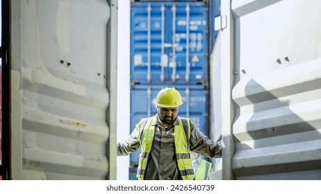 African American Industrial Engineer and Asian Supervisor in Hard Hats and Safety Vests Opening a Shipping Cargo Container in Logistics Terminal. Supervisor Presenting containers for shipping, import - Powered by Shutterstock