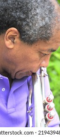 African American Jazz Musician With His Flugelhorn Outside.