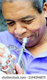 African American Jazz Musician With His Flugelhorn Outside.