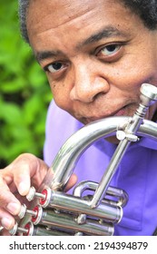 African American Jazz Musician With His Flugelhorn Outside.