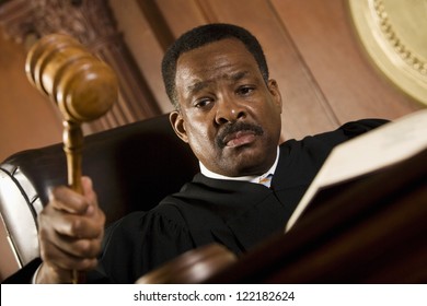African American judge pounding mallet in courtroom