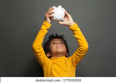 African American Kid Boy With Empty Piggy Bank