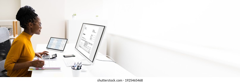 African American Lady Using Computer For Online Invoice Calculation
