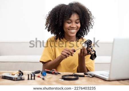 African American learning at home in coding robot cars and electronic board cables in STEM, STEAM, mathematics engineering science technology. Coding  on tablet concept