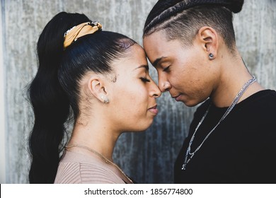 African American lesbian couple touching foreheads in tender mom