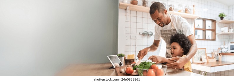 African American Little Afro child boy and his father cooking together in the kitchen at home - Powered by Shutterstock