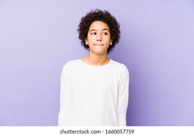 African american little boy isolated confused, feels doubtful and unsure.