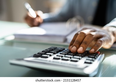 African American Male Accountant Using Calculator For Accounting