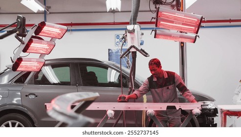 African American male car mechanic working in a township workshop, using a grinder on a piece of a car in slow motion - Powered by Shutterstock