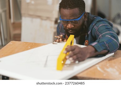 African American male carpenter working at wood factory. Male joiner in wood factory - Powered by Shutterstock