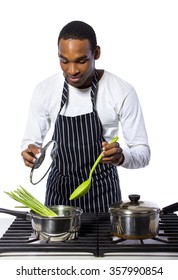 African American Male Chef Wearing An Apron Cooking Isolated On A White Background