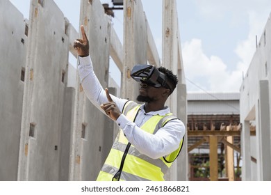 African American male construction engineer wearing virtual reality headset inspecting quality of structural at construction site. Male construction engineer working with VR headset at site work - Powered by Shutterstock