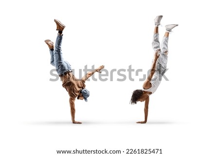 African american male dancer and a caucasian performing a handstand isolated on white background