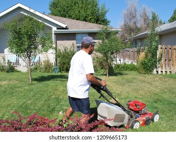 African American Male Doing Yardwork At Home.