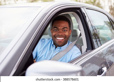 African American Male Driver Looking To Camera Through Car Window