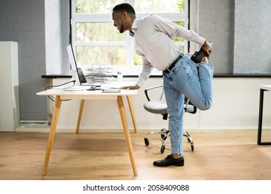 African American Male Exercise Office. Stretching Workout