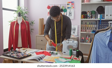 African american male tailor working attentively in a vibrant atelier with fabrics and sewing machine. - Powered by Shutterstock