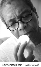 African American Male Taking His Medication At Home.