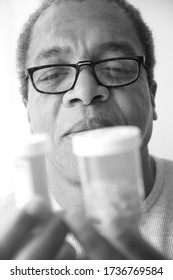 African American Male Taking His Medication At Home.