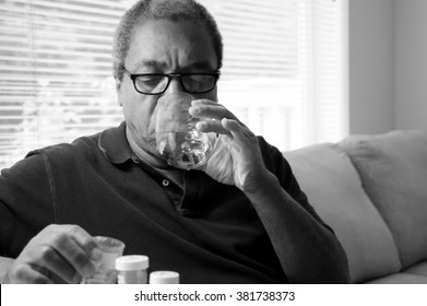 African American Male Taking His High Blood Pressure Medication.