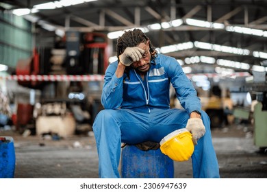 African American male technician feel tired from hard work in a repaired mechanic workshop manufacture, weak, hopeless, burned out, hot, fired unemployed feeling stressed. - Powered by Shutterstock