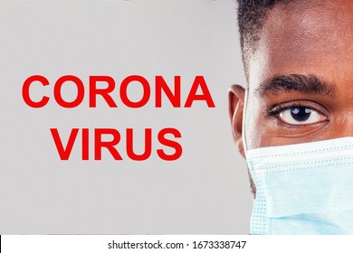 African American Male Wearing On A Gauze Mask Close Up Eyes White Background Studio Covid Infection Epidemia Concept.