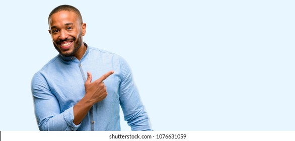 African American Man With Beard Pointing Away Side With Finger Isolated Over Blue Background