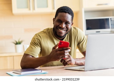 African American Man In Beige T-shirt Record Voice Message By Mobile Cell Phone At Home