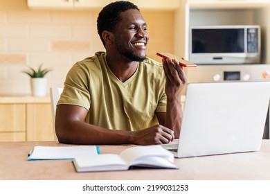 African American Man In Beige T-shirt Record Voice Message By Mobile Cell Phone At Home