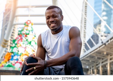 African American Man With Black Skin Currently Having A Knee Injury After Exercise,Sports And Physical Injury Concept.