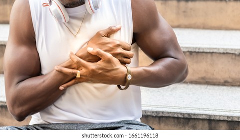 African American Man With Black Skin He Is And Athlete, He Is Having Pain In The Chest Due To Heart Disease,  To People And Health Care Concept