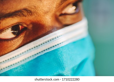 african american man in blue and white surgical  face mask