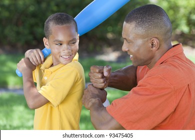 African American Man & Boy Child, Father And Son Playing Baseball Together Outside.