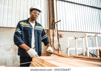 African American man carpenter working in wood business workshop. black people technician craftman, Timber industry tool factory, woodwork for construction or wooden furniture job - Powered by Shutterstock