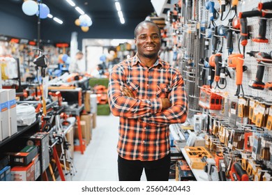 A african american man chooses a power tool in a hardware store.