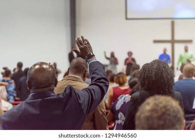 African American Man at Church with His Hand Raised