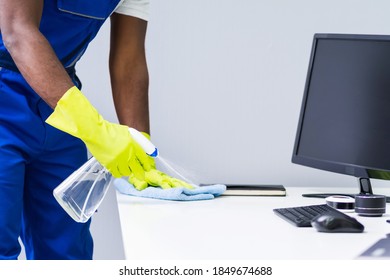 African American Man Cleaning Office Computer Desk