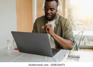 African American Man Doing Video Call On Computer Laptop For Business Meeting At Bar Restaurant - Focus On Face