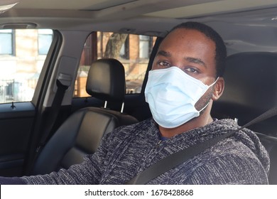 
African American Man Driving Car Wearing Medical Mask