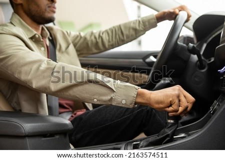 African american man driving his car shifting gears