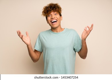 African american man with green shirt smiling a lot - Shutterstock ID 1453407254