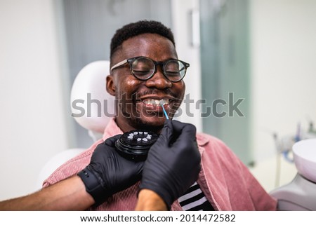 African American man having dental treatment with lumineers at dentist's office.