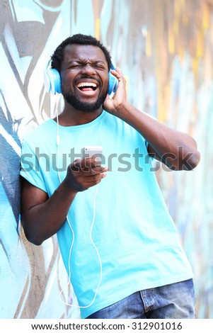 Similar – Young happy black man is listening to music