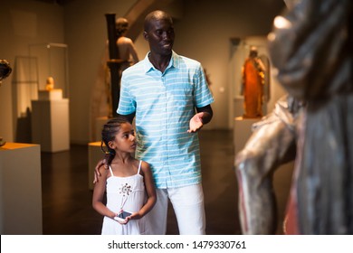 African American Man And His Daughter Visiting Exposition Of Museum With Exhibits Of Medieval Art