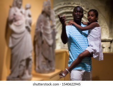 African American Man And His Daughter Visiting Exposition Of Museum With Exhibits Of Medieval Art