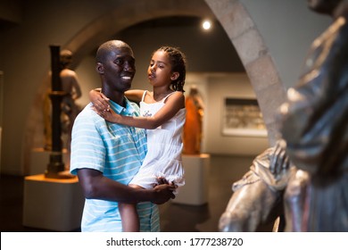 African American Man And His Daughter Visiting Exposition Of Museum With Exhibits Of Medieval Art