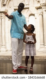 African American Man And His Daughter Visiting Exposition Of Museum With Exhibits Of Medieval Art